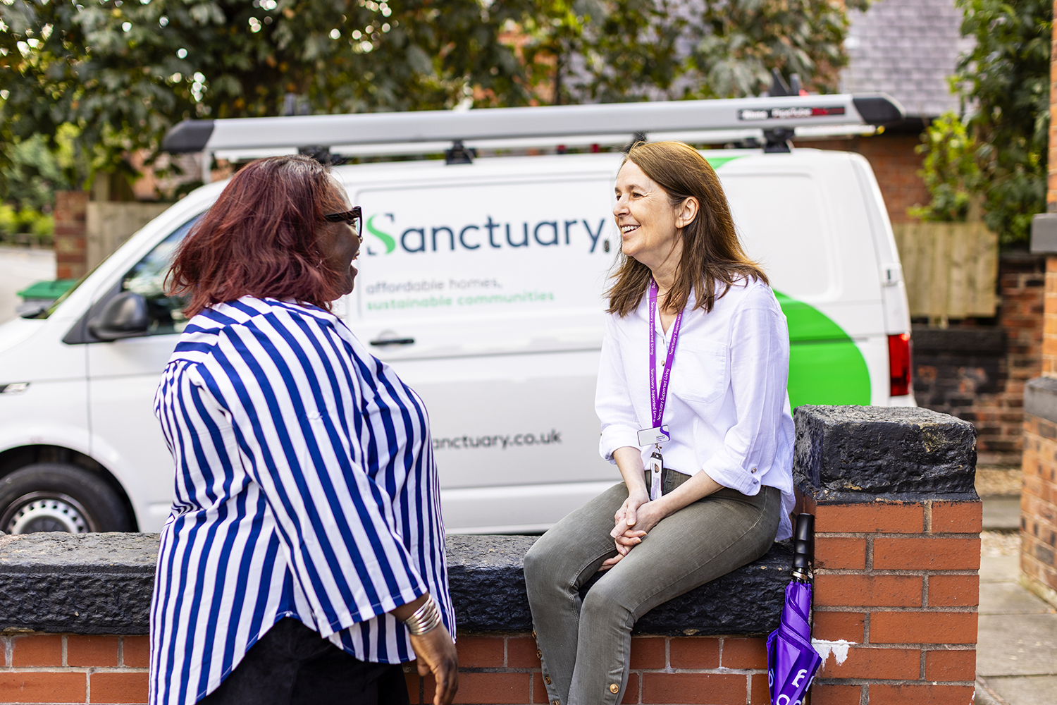 Housing association staff conversation outside supported living property captured by Birmingham lifestyle photographer