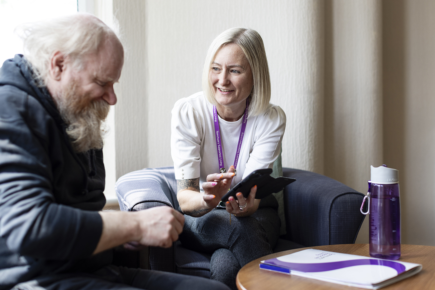 Housing support worker meeting tenant in supported living setting captured for public sector communications