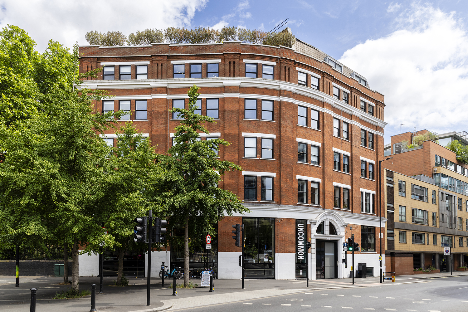 Red brick co-working office building in London photographed by architectural photographer London on bright summer day