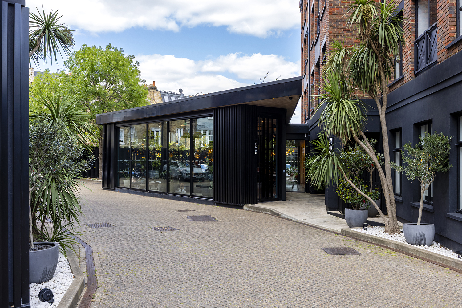 Contemporary glass and black cladding office entrance in London captured by architectural photographer London