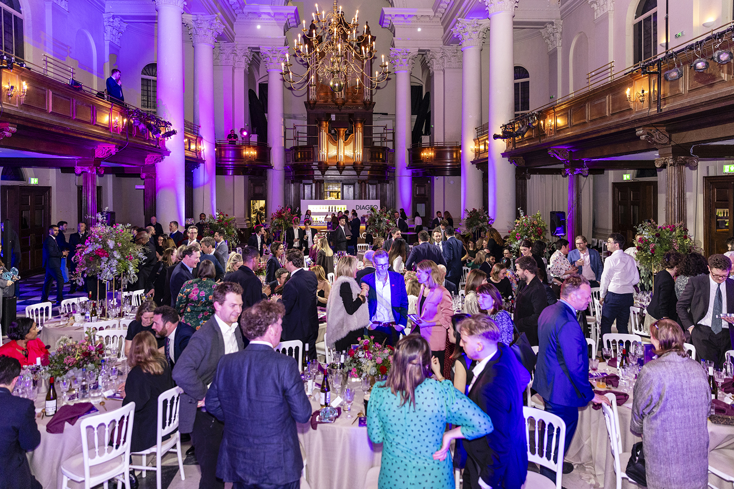 Wide view of awards dinner event inside grand London venue with chandeliers