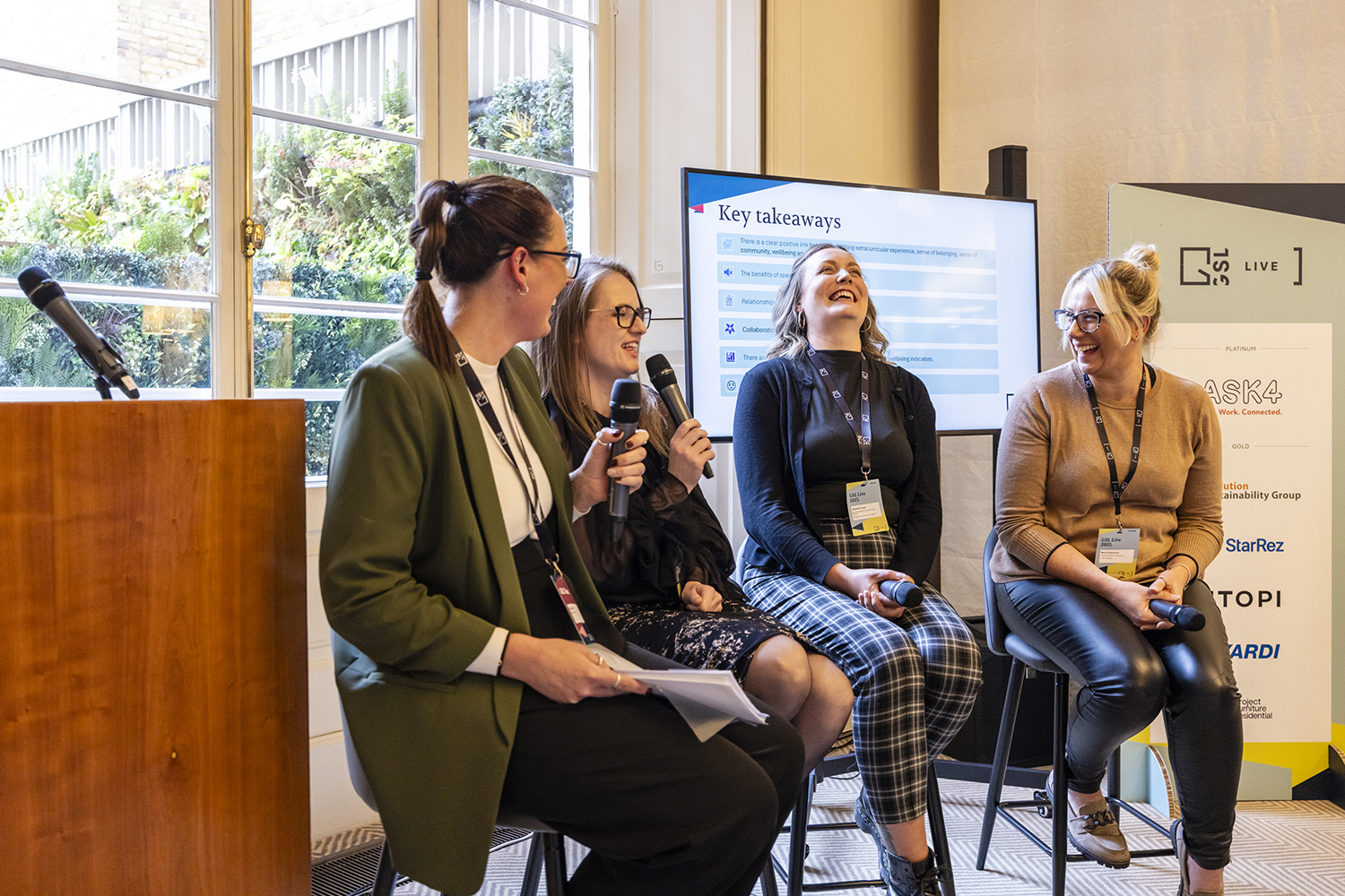 Panel discussion at London conference with seated speakers and audience engagement