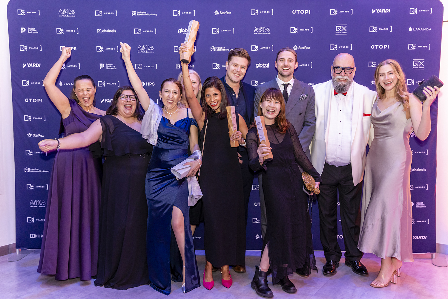 Award winners holding trophies during evening celebration event in London