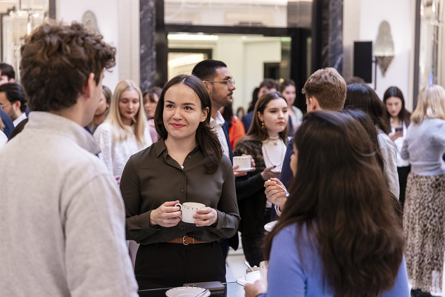 Business professionals networking with coffee at Claridge’s London corporate event