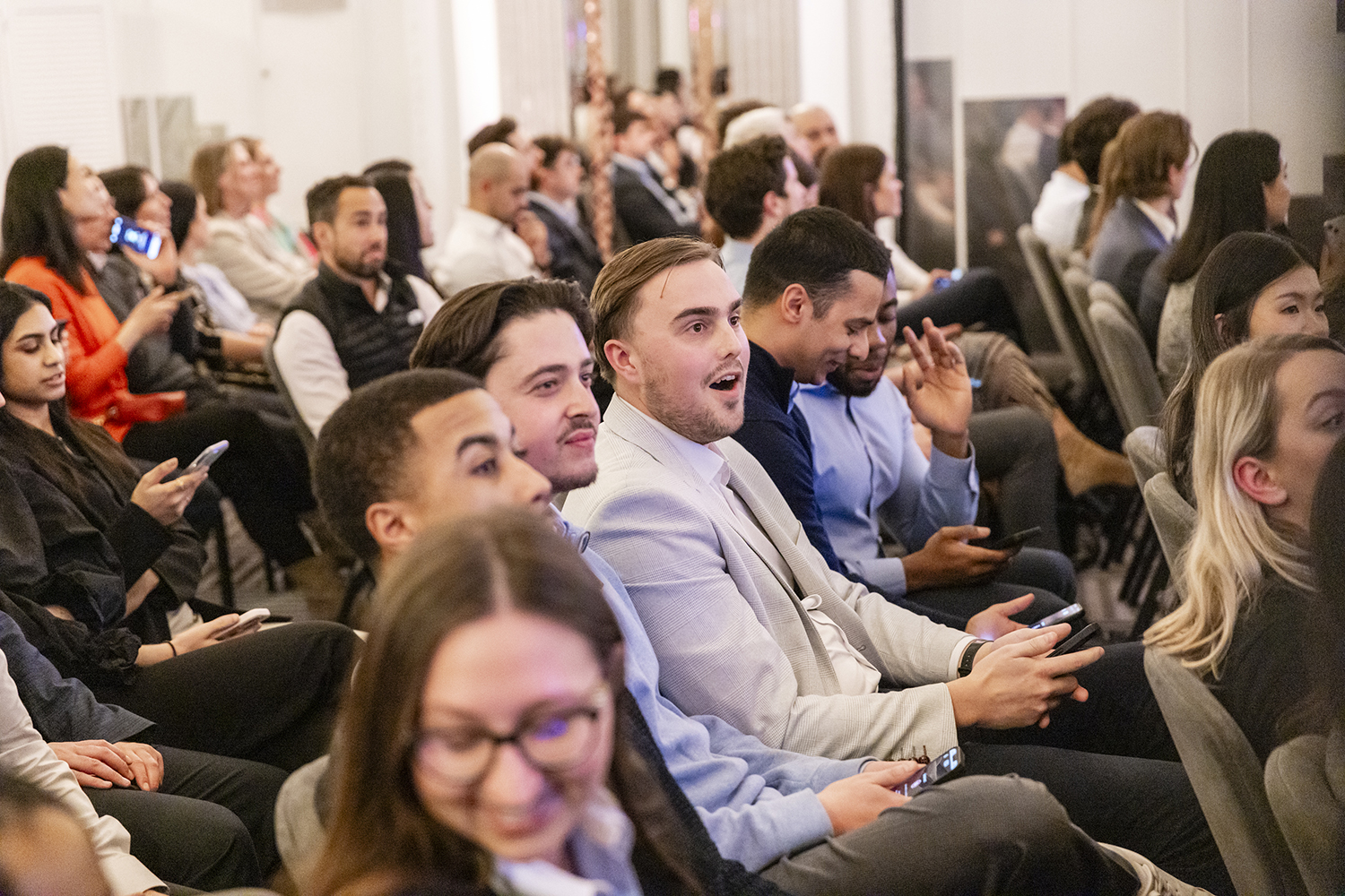 Candid audience reactions during finance sector event at Claridge’s London